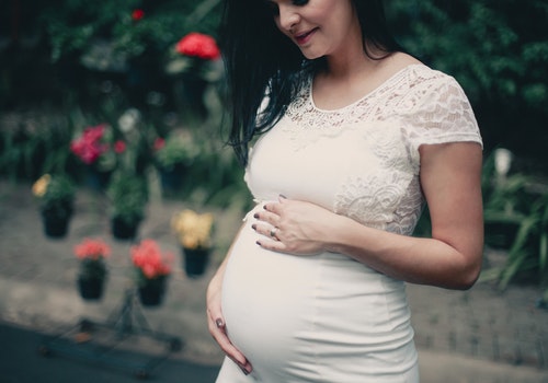 pregnant woman holding her belly