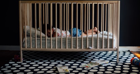 Toddler girl laying in the crib