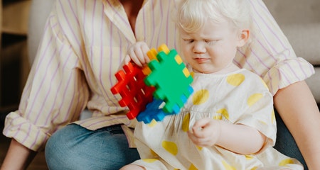 A baby girl playing with toy