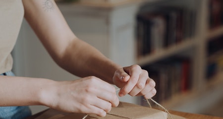 A person is tying up the book