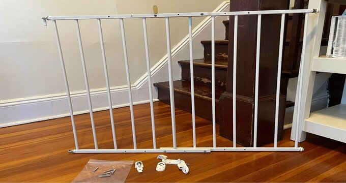 A baby gate next to the stairs