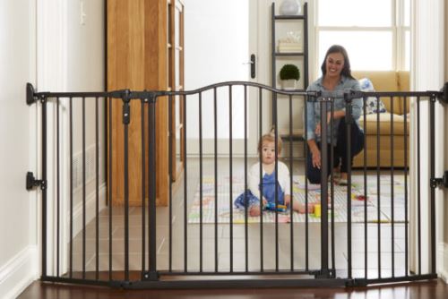 Baby girl and mom playing next to the baby gate