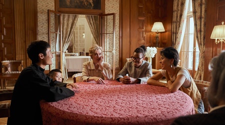 Family sitting at the table and talking to each other 