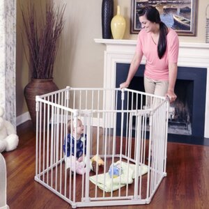Mom is smiling at her baby next to the Curved Baby Gates