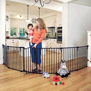 A woman standing with her kid next tot he Toddleroo by North States 3 in 1 baby gate