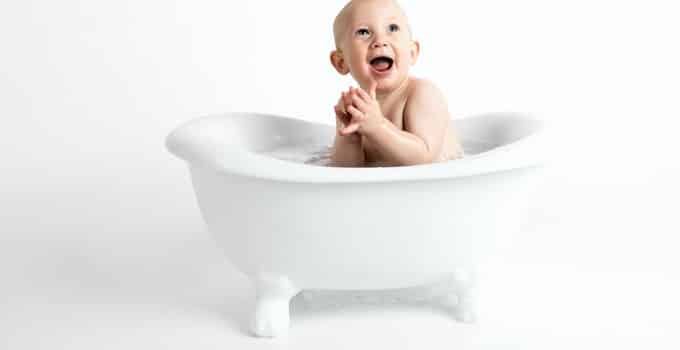 Baby taking shower in the bathtub