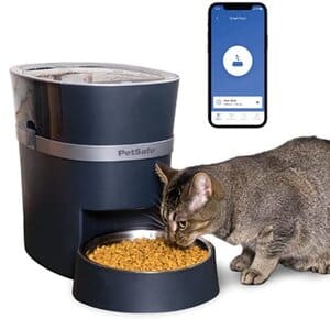 A cat is eating food from a Dog and Cat Feeder