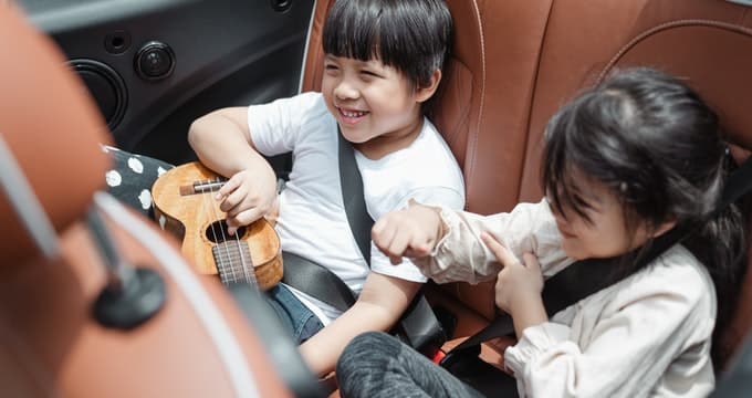 Two kids travelling on a car